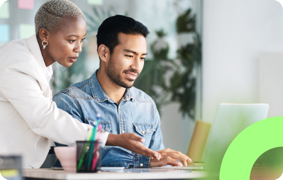 Two people working together on a laptop working on a project.